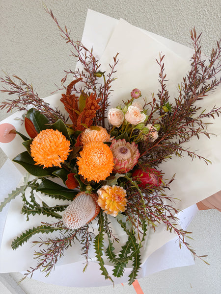 Wild bouquet, full of rustic oranges, and natives, accompanied with natives and wild foliage. 